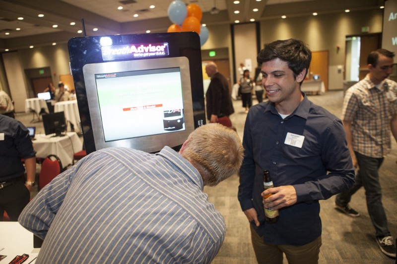 Sebastian Hooker, marketing director of breathalyzer kiosk company BreathAdvisor, demonstrates his company's product. (photo: Joey Ferguson)